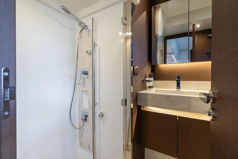  Yacht Photos Pics Luxurious bathroom interior of 2022 Prestige 520 yacht, featuring modern shower and sleek vanity.