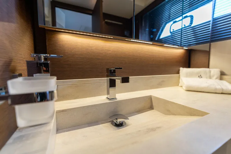  Yacht Photos Pics Modern bathroom sink in 2022 Prestige 520 yacht, featuring sleek design and ambient lighting.