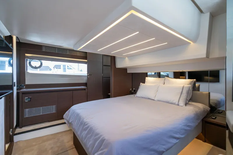  Yacht Photos Pics Luxurious bedroom interior of 2022 Prestige 520 yacht with modern lighting and elegant design.