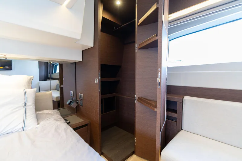  Yacht Photos Pics Luxurious interior of 2022 Prestige 520 yacht with open closet and modern furnishings.