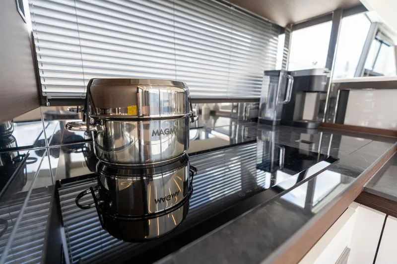  Yacht Photos Pics Modern kitchen in 2022 Prestige 520 yacht with sleek stovetop and cookware.