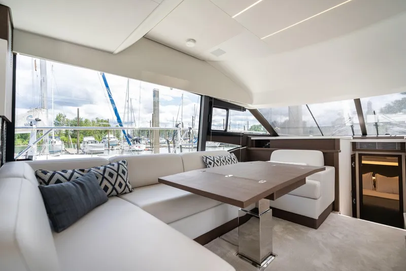  Yacht Photos Pics Luxurious interior of 2022 Prestige 520 yacht with elegant seating and marina view.