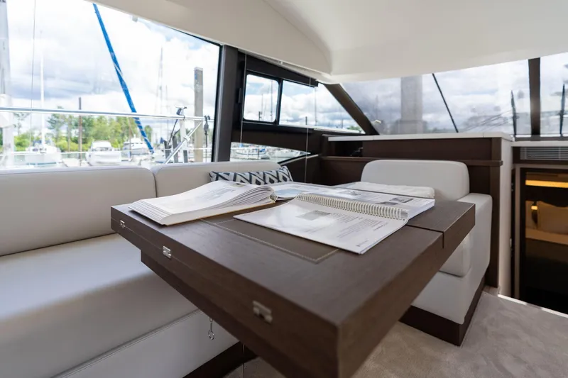  Yacht Photos Pics Luxurious interior of 2022 Prestige 520 yacht with elegant seating and table.