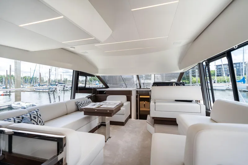  Yacht Photos Pics Luxurious interior of 2022 Prestige 520 yacht with modern seating and marina view.