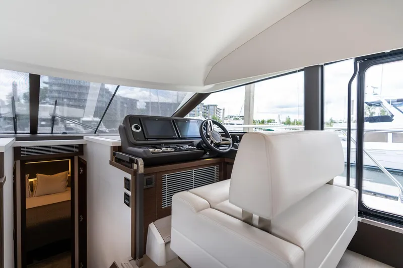  Yacht Photos Pics Interior of 2022 Prestige 520 yacht with helm station and cabin entrance.