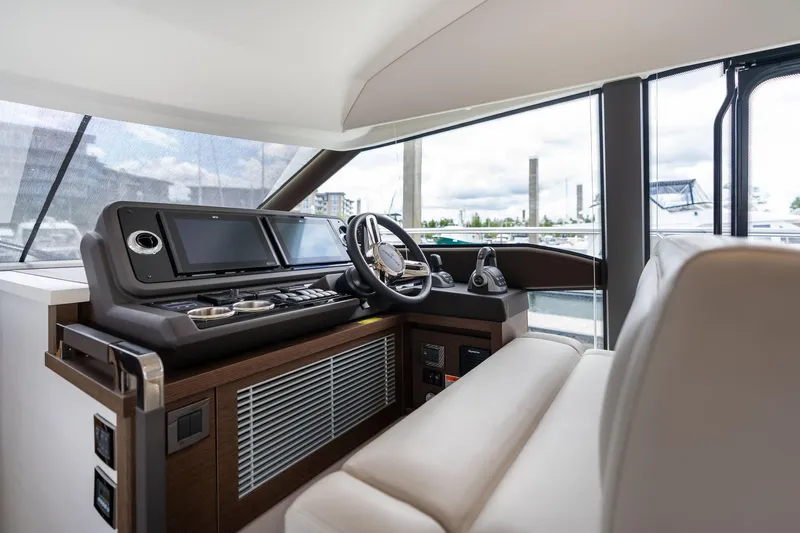  Yacht Photos Pics Luxurious interior of 2022 Prestige 520 yacht with modern helm and navigation controls.
