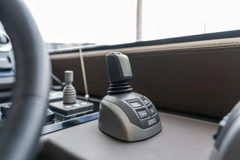  Yacht Photos Pics Control panel of a 2022 Prestige 520 yacht with joystick and buttons.