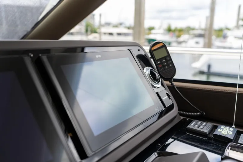  Yacht Photos Pics Control panel of a 2022 Prestige 520 yacht with navigation screens and communication device.