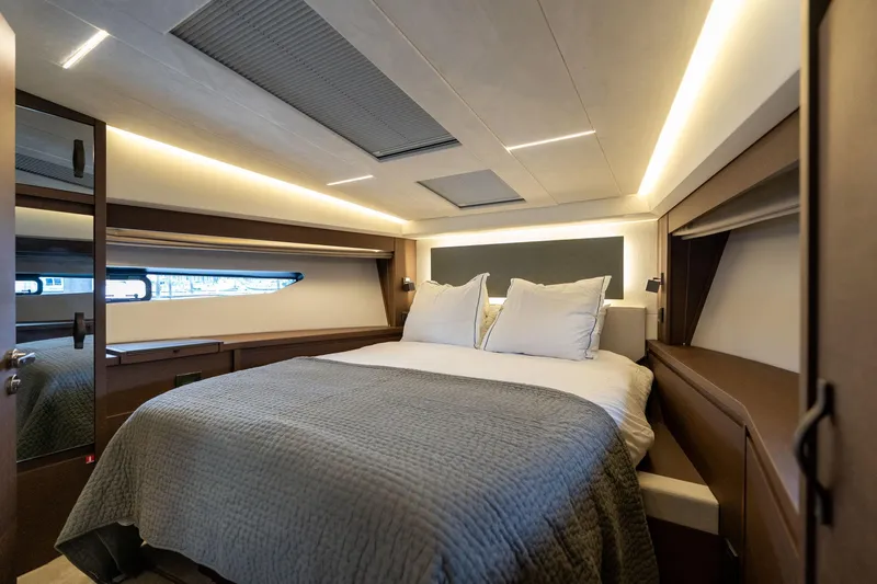  Yacht Photos Pics Luxurious bedroom interior of 2022 Prestige 520 yacht with modern lighting and cozy bedding.