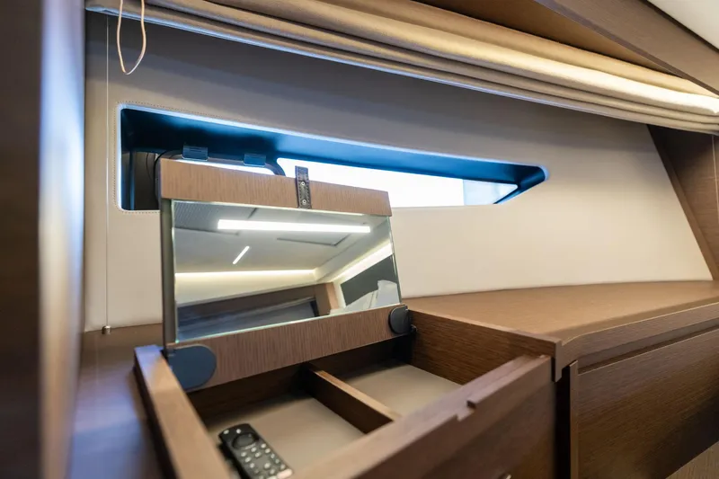  Yacht Photos Pics Interior of 2022 Prestige 520 yacht with wooden cabinetry and mirror.