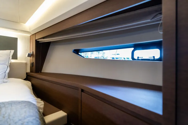  Yacht Photos Pics Luxurious interior of 2022 Prestige 520 yacht with sleek wood finish and window view.