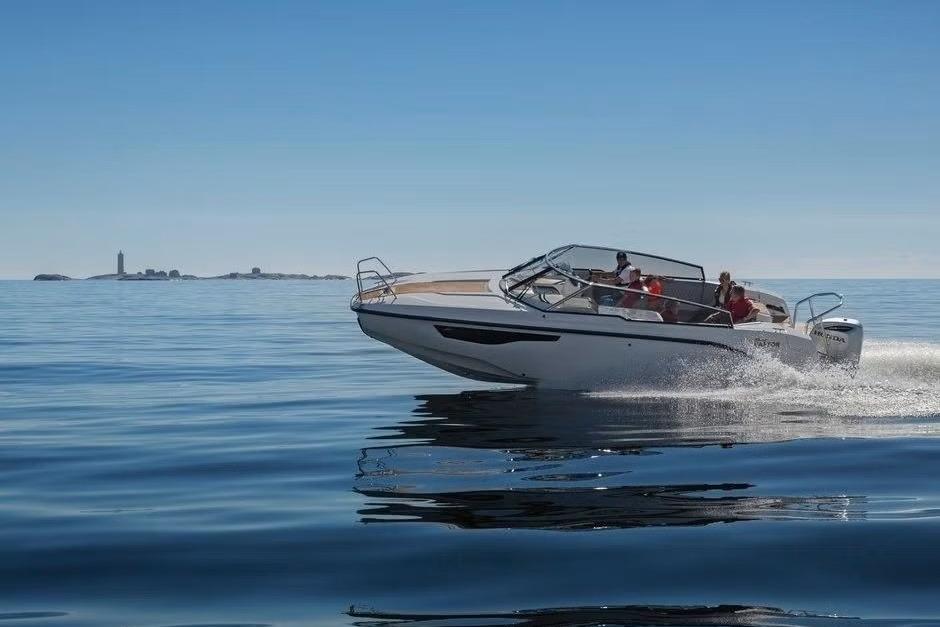 2023 Silver Raptor DCz boat cruising on calm ocean waters under clear blue sky.