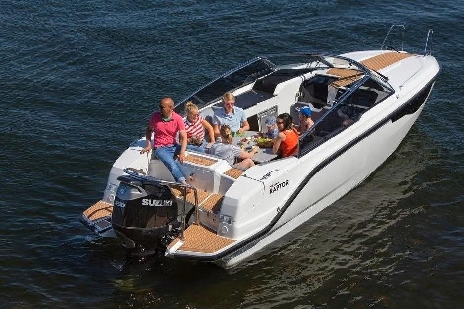 2023 Silver Raptor DCz boat with people enjoying a sunny day on the water.