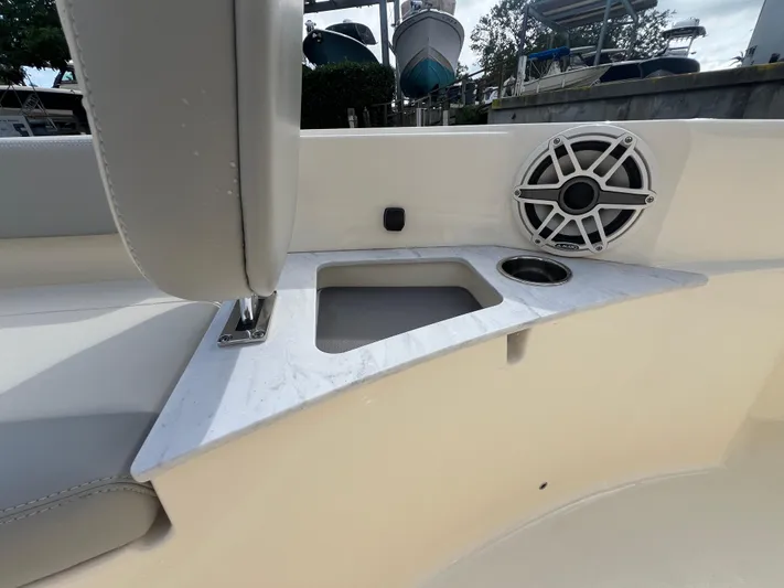  Yacht Photos Pics 2025 Scout 261 XSS boat interior with speaker and cup holder on white surface.