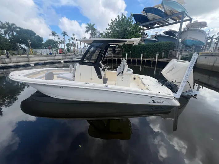  Yacht Photos Pics 2025 Scout 261 XSS boat docked on calm water under a cloudy sky.