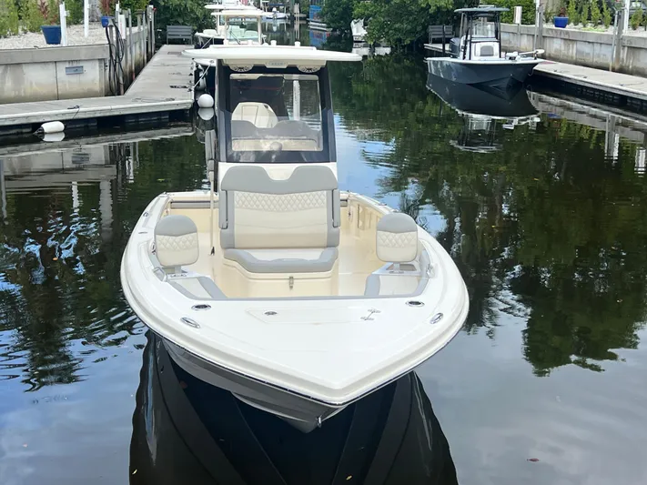  Yacht Photos Pics 2025 Scout 261 XSS boat docked in a serene marina setting.