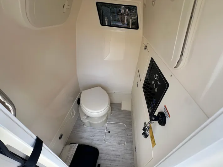 Yacht Photos Pics 2025 Scout 261 XSS boat interior with compact bathroom and control panel.