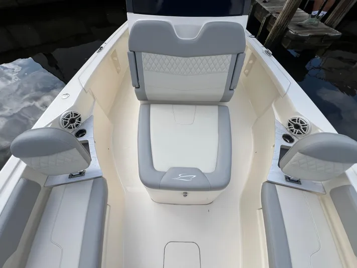  Yacht Photos Pics 2025 Scout 261 XSS boat interior with gray and white seating, cup holders, and speakers.