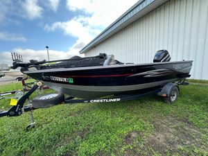 2013 Crestliner Fish Hawk 1650 SC boat on trailer, parked on grass.