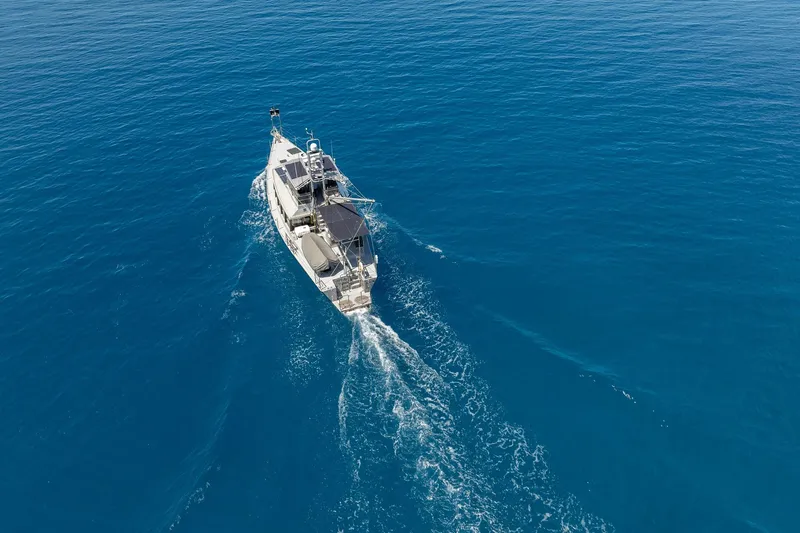 Toccata Yacht Photos Pics Aerial view of 2011 Circa Marine FPB64 yacht cruising in clear blue ocean.