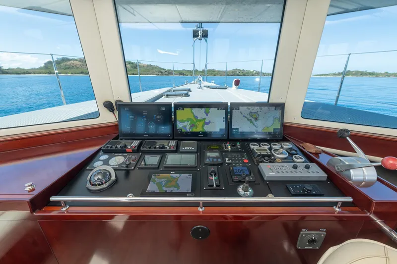 Toccata Yacht Photos Pics Control panel of 2011 Circa Marine FPB64 yacht with navigation screens and instruments.