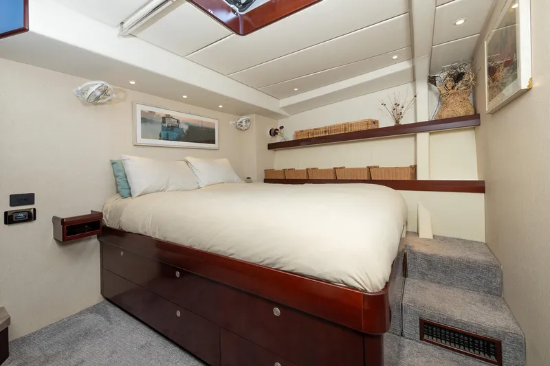 Toccata Yacht Photos Pics Luxurious bedroom interior of 2011 Circa Marine FPB64 yacht with elegant wood finishes.