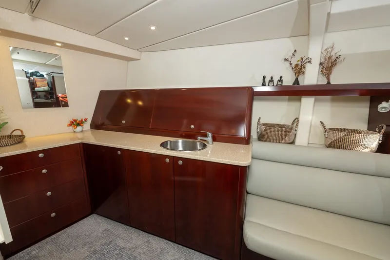Toccata Yacht Photos Pics Luxurious interior of 2011 Circa Marine FPB64 yacht with elegant wood cabinetry and seating.