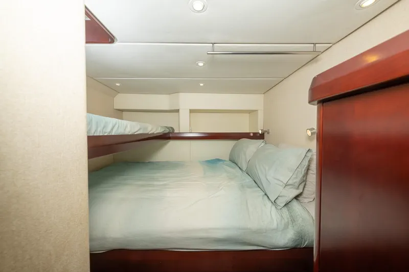 Toccata Yacht Photos Pics 2011 Circa Marine FPB64 yacht cabin with cozy bunk beds and wooden accents.