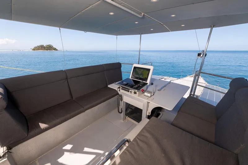 Toccata Yacht Photos Pics Luxurious 2011 Circa Marine FPB64 yacht helm with ocean view and island in background.