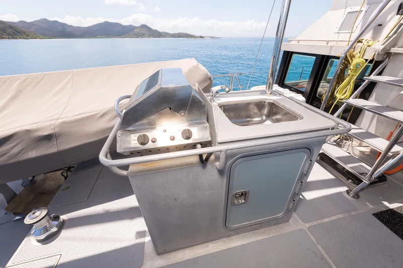 Toccata Yacht Photos Pics Outdoor kitchen on 2011 Circa Marine FPB64 yacht with grill and sink, ocean view.