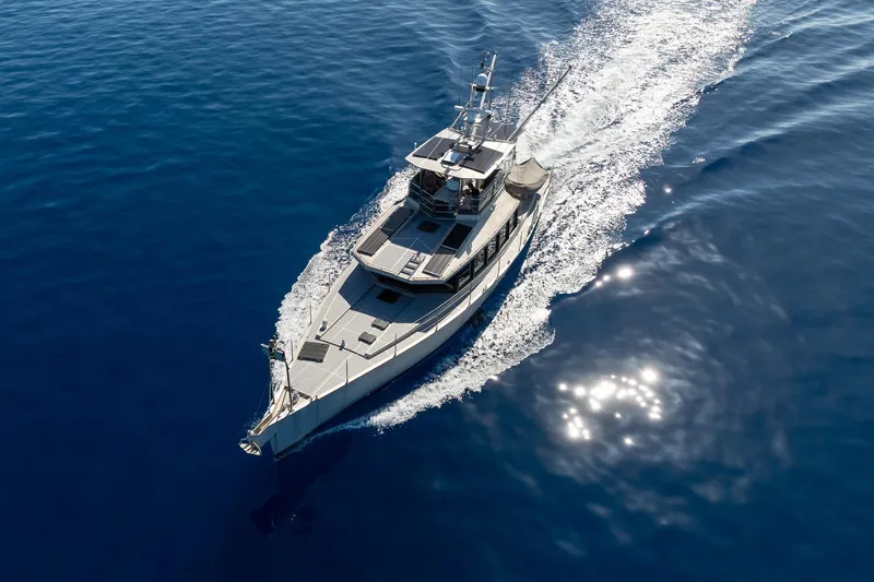 Toccata Yacht Photos Pics Aerial view of 2011 Circa Marine FPB64 yacht cruising on open blue sea.