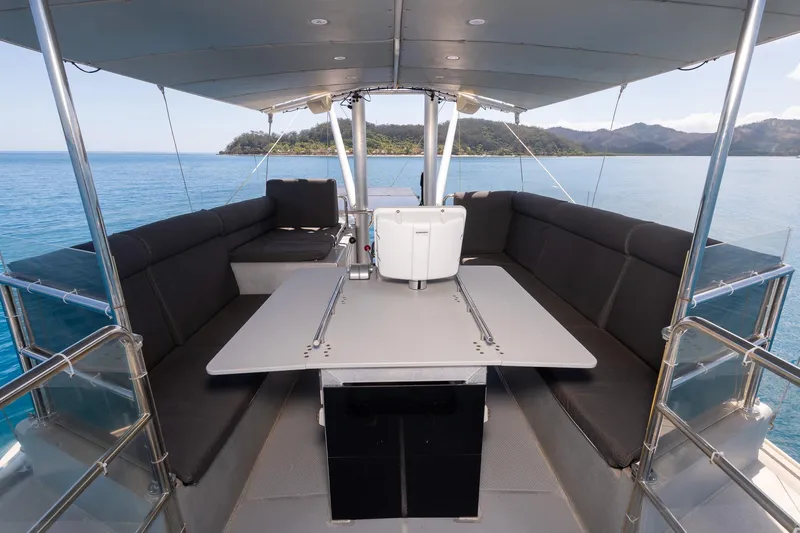 Toccata Yacht Photos Pics Luxurious 2011 Circa Marine FPB64 yacht deck with seating and ocean view.