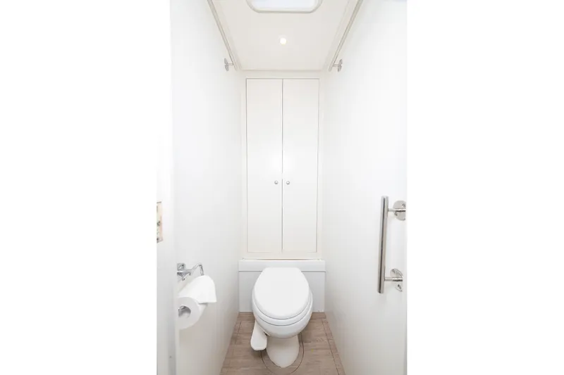 Toccata Yacht Photos Pics Compact marine bathroom with toilet and storage on Circa Marine FPB64, 2011 model.