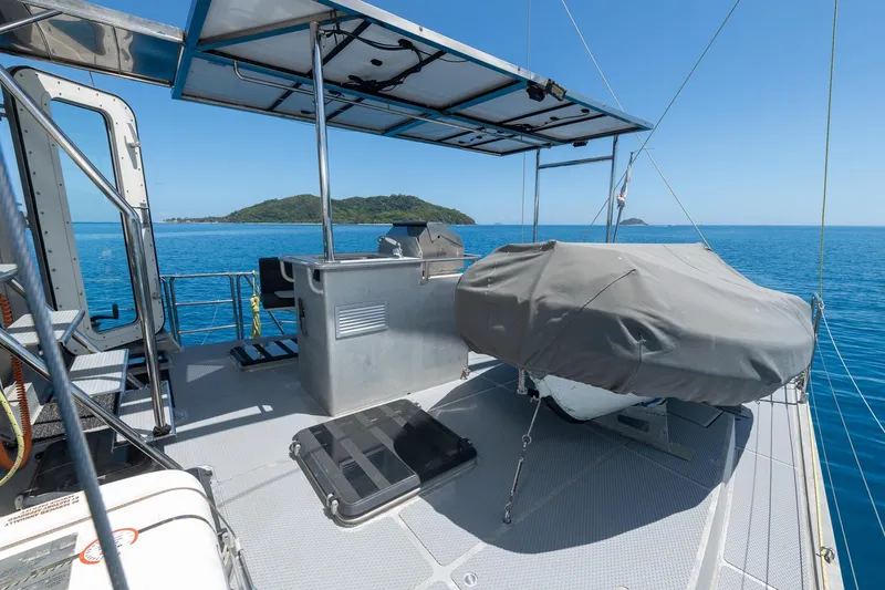 Toccata Yacht Photos Pics Deck view of 2011 Circa Marine FPB64 yacht with ocean and island backdrop.