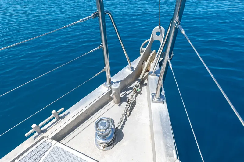 Toccata Yacht Photos Pics Bow of 2011 Circa Marine FPB64 yacht with anchor and winch over blue sea.