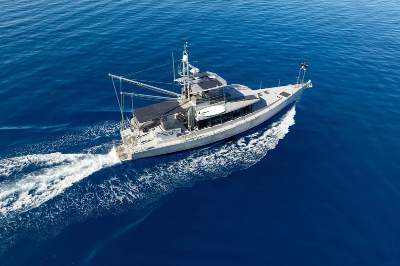 Toccata Yacht Photos Pics Aerial view of 2011 Circa Marine FPB64 yacht cruising on open blue sea.