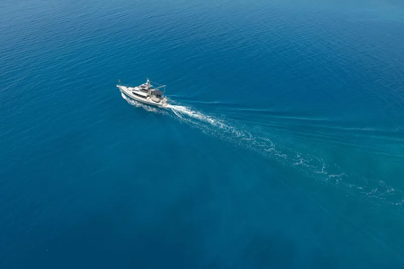 Toccata Yacht Photos Pics Aerial view of 2011 Circa Marine FPB64 yacht cruising in open blue sea.