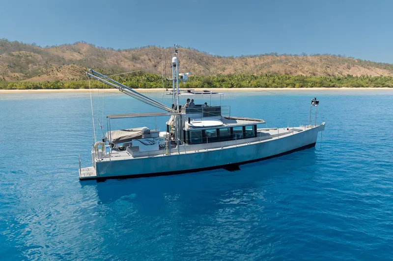 Toccata Yacht Photos Pics Circa Marine FPB64 yacht, 2011 model, cruising in clear blue waters near a scenic coastline.