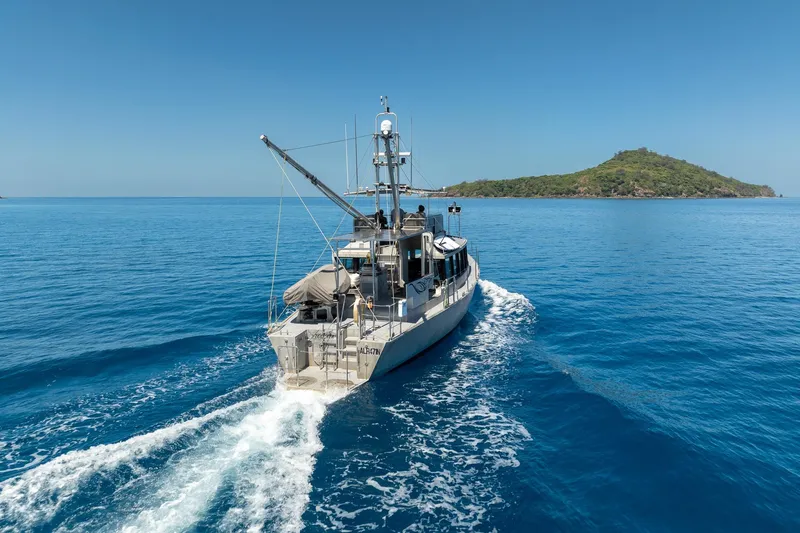 Toccata Yacht Photos Pics Circa Marine FPB64 yacht cruising near an island, 2011 model, in clear blue waters.