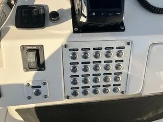  Yacht Photos Pics Control panel of a 2016 Intrepid 400 Center Console boat with multiple switches.