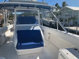  Yacht Photos Pics 2016 Intrepid 400 Center Console boat with blue seating, docked near waterfront homes.
