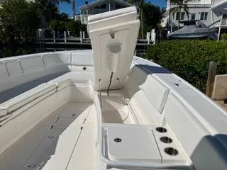  Yacht Photos Pics 2016 Intrepid 400 Center Console boat with open storage compartment, docked near waterfront homes.