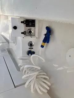  Yacht Photos Pics 2016 Intrepid 400 Center Console boat deck with coiled hose and control panel.