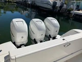  Yacht Photos Pics 2016 Intrepid 400 Center Console with triple Mercury outboard engines docked by the water.