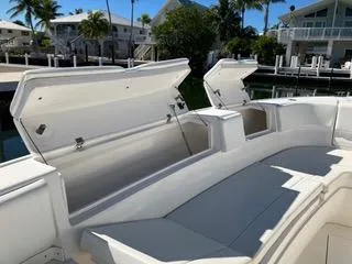  Yacht Photos Pics 2016 Intrepid 400 Center Console boat with open storage compartments, docked near waterfront homes.