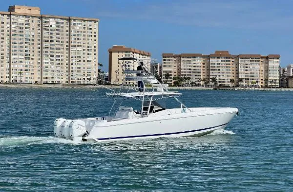  Yacht Photos Pics 2016 Intrepid 400 Center Console boat cruising near waterfront buildings.