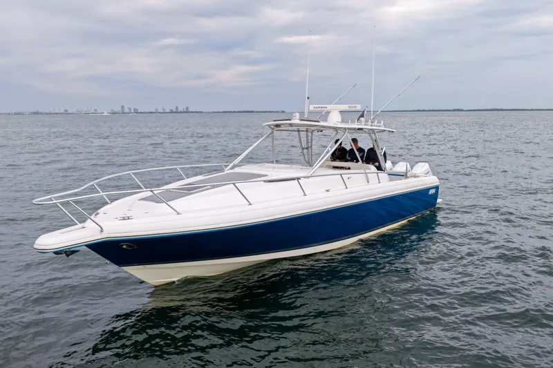  Yacht Photos Pics 2003 Intrepid 377 Walkaround boat on open water, featuring a sleek blue and white design.