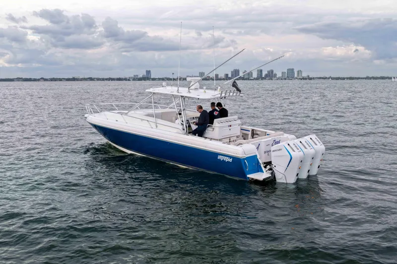  Yacht Photos Pics 2003 Intrepid 377 Walkaround boat on water with city skyline in background.