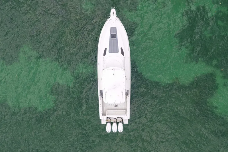  Yacht Photos Pics Aerial view of 2003 Intrepid 377 Walkaround boat on green water.