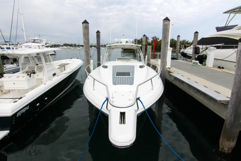  Yacht Photos Pics 2003 Intrepid 377 Walkaround boat docked at marina, front view.